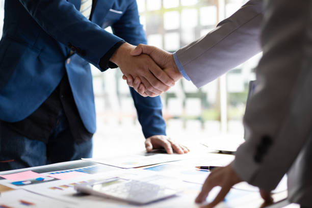Better Together: Performance-Based Cost Reduction Partners Business partnership handshake representing performance-based cost reduction consulting working better together for small businesses
